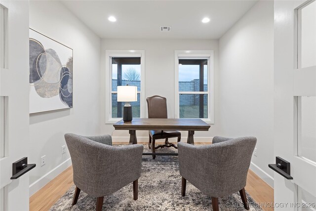 home office with recessed lighting, visible vents, light wood-type flooring, and a healthy amount of sunlight