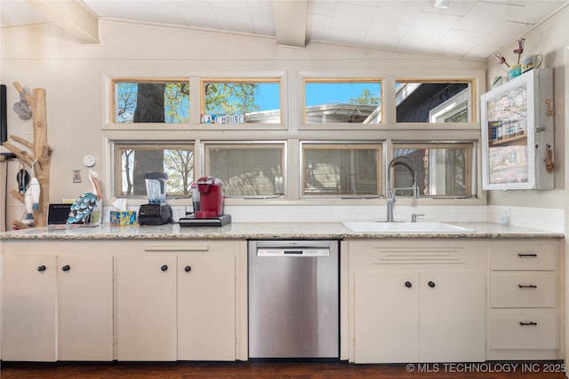 449774 E 356th Rd, Afton, OK 74331 - kitchen featuring white cabinets, a healthy amount of sunlight, stainless steel dishwasher, a sink, and lofted ceiling with beams