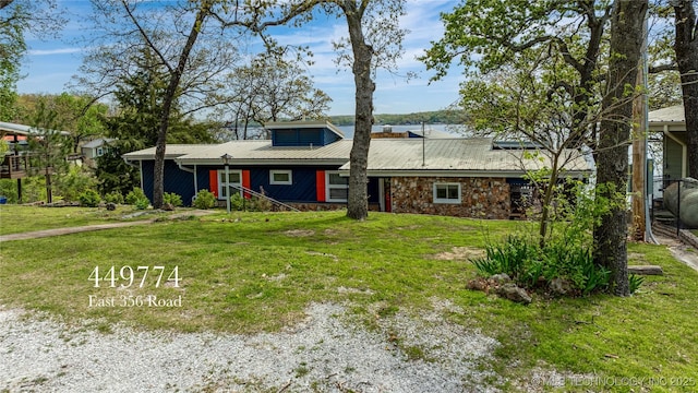 449774 E 356th Rd, Afton, OK 74331 - view of front of house featuring stone siding, a front lawn, and metal roof