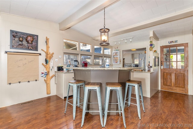 449774 E 356th Rd, Afton, OK 74331 - kitchen with visible vents, dark wood-style floors, a breakfast bar area, and pendant lighting