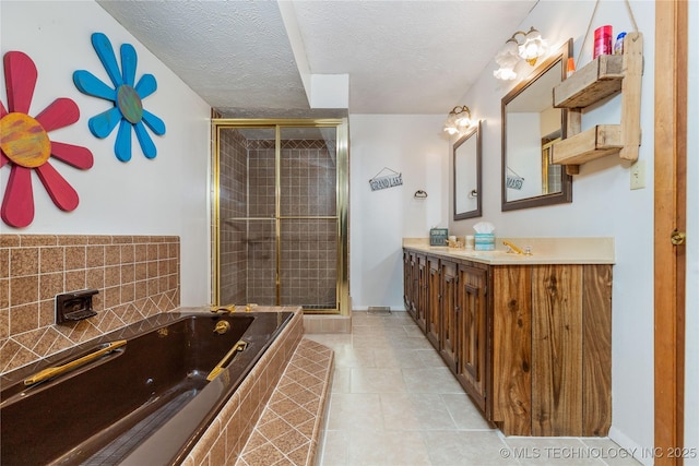 449774 E 356th Rd, Afton, OK 74331 - bathroom featuring tile patterned floors, a textured ceiling, a stall shower, a garden tub, and vanity