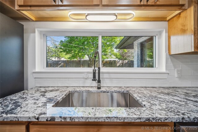 2615 E 59th St, Tulsa, OK 74105 - room details featuring a sink, tasteful backsplash, and light stone countertops