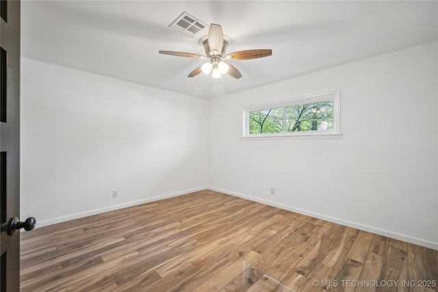 2615 E 59th St, Tulsa, OK 74105 - unfurnished room featuring a ceiling fan, baseboards, visible vents, and wood finished floors