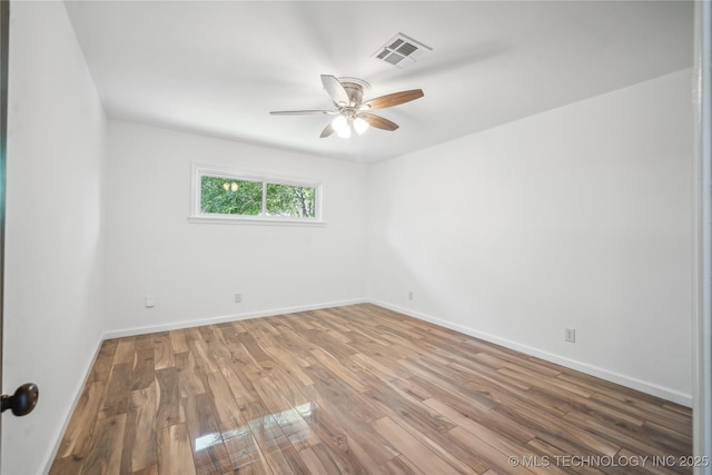 2615 E 59th St, Tulsa, OK 74105 - spare room featuring baseboards, a ceiling fan, wood finished floors, and visible vents