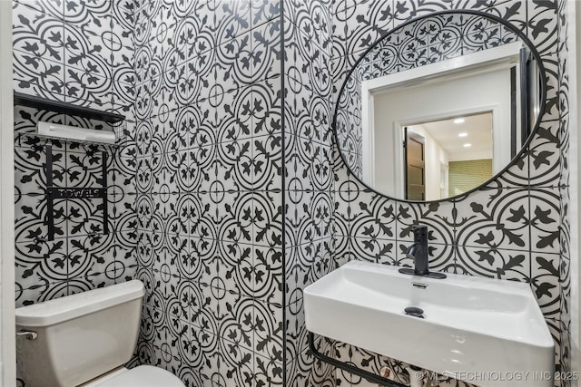 2615 E 59th St, Tulsa, OK 74105 - bathroom featuring a sink, tile walls, and toilet