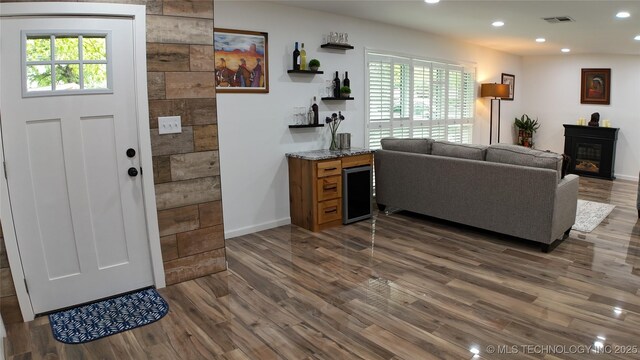 2615 E 59th St, Tulsa, OK 74105 - living area featuring visible vents, a glass covered fireplace, wood finished floors, baseboards, and recessed lighting