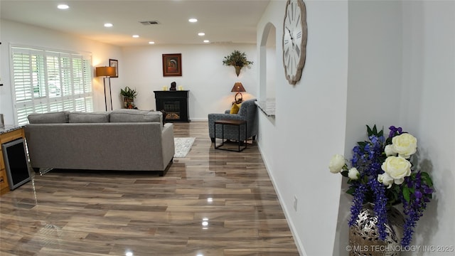 2615 E 59th St, Tulsa, OK 74105 - living room featuring visible vents, a glass covered fireplace, wood finished floors, baseboards, and recessed lighting