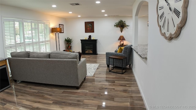 2615 E 59th St, Tulsa, OK 74105 - living area featuring arched walkways, recessed lighting, dark wood-style floors, and visible vents