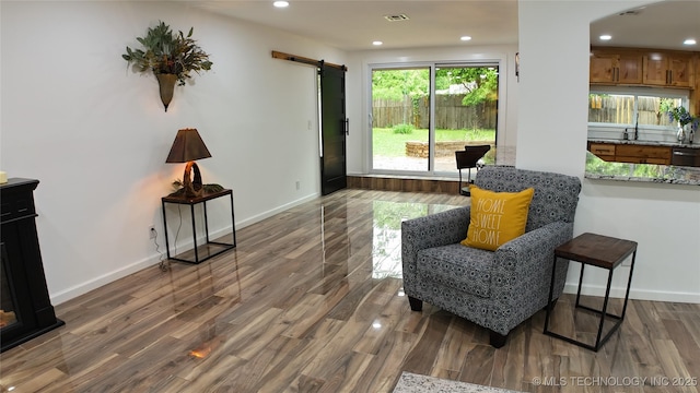 2615 E 59th St, Tulsa, OK 74105 - living area with visible vents, wood finished floors, a barn door, baseboards, and recessed lighting