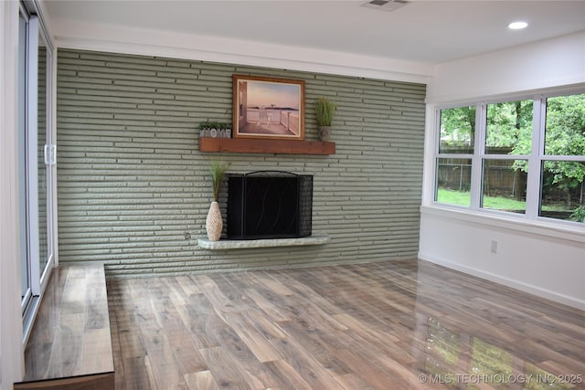 2615 E 59th St, Tulsa, OK 74105 - unfurnished living room featuring a brick fireplace, recessed lighting, baseboards, wood finished floors, and visible vents