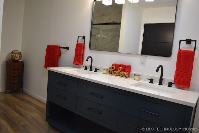2615 E 59th St, Tulsa, OK 74105 - full bath with a sink, double vanity, a shower stall, and wood finished floors