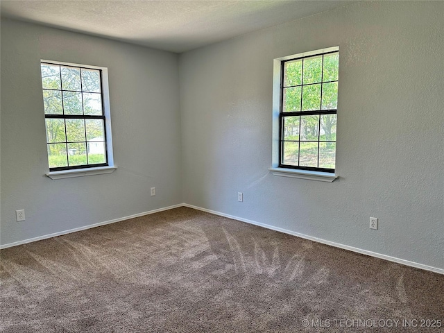 4665 Primrose, Sulphur, OK 73086 - empty room with dark carpet, baseboards, and a textured wall