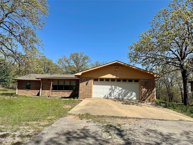4665 Primrose, Sulphur, OK 73086 - view of front facade with brick siding, an attached garage, concrete driveway, and a front yard
