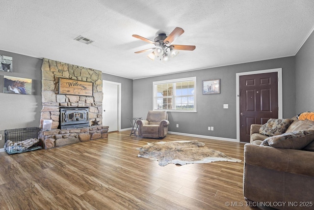 9720 S 4475th Rd, Miami, OK 74354 - living room with visible vents, a ceiling fan, wood finished floors, and a textured ceiling