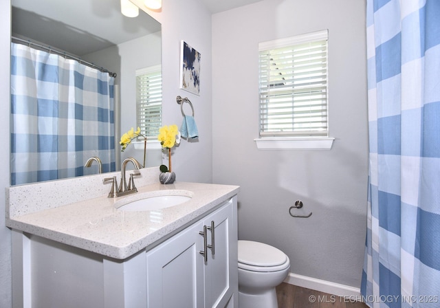 27616 E 109th Pl S, Coweta, OK 74429 - bathroom with toilet, wood finished floors, baseboards, vanity, and a shower with shower curtain