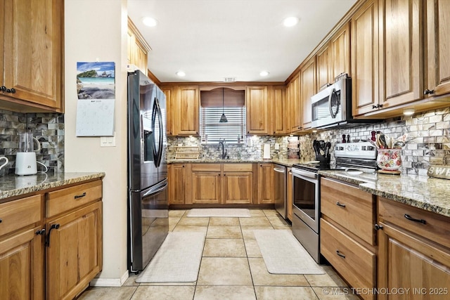 2909 Haddock Dr, Muskogee, OK 74401 - kitchen with brown cabinetry, tasteful backsplash, light stone countertops, light tile patterned floors, and stainless steel appliances