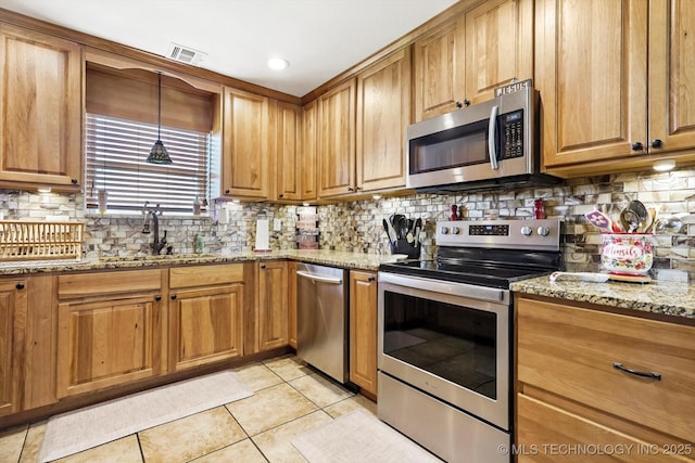 2909 Haddock Dr, Muskogee, OK 74401 - kitchen with visible vents, appliances with stainless steel finishes, light stone countertops, a sink, and light tile patterned floors