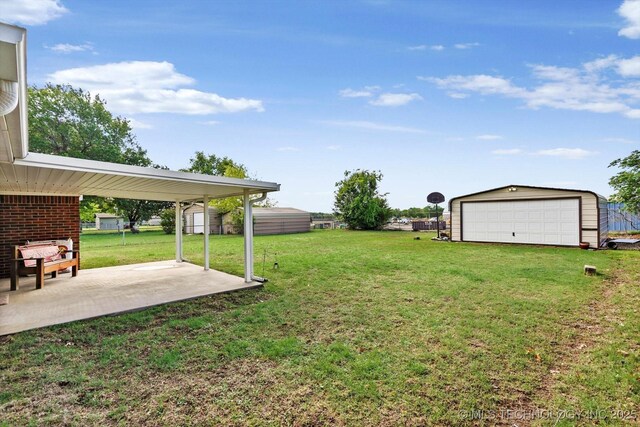 2909 Haddock Dr, Muskogee, OK 74401 - view of yard featuring a detached garage, an outdoor structure, and a patio area