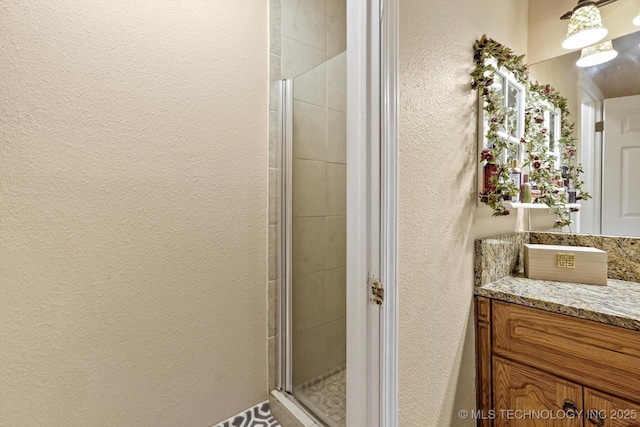 2909 Haddock Dr, Muskogee, OK 74401 - bathroom featuring vanity, a textured wall, and a stall shower