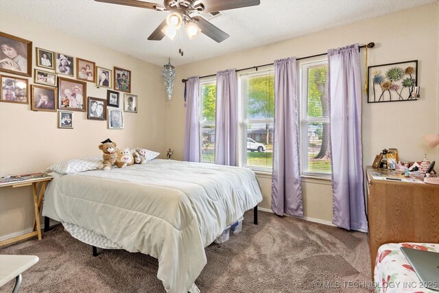 2909 Haddock Dr, Muskogee, OK 74401 - carpeted bedroom featuring baseboards and ceiling fan