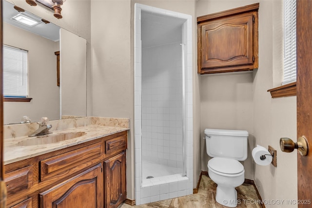bathroom featuring visible vents, baseboards, toilet, vanity, and a stall shower