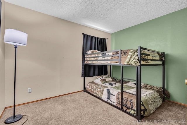 bedroom featuring a textured ceiling, baseboards, and carpet floors