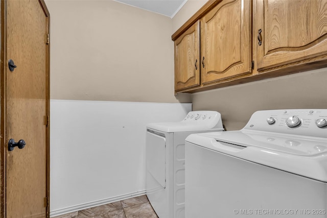 laundry room featuring cabinet space and separate washer and dryer
