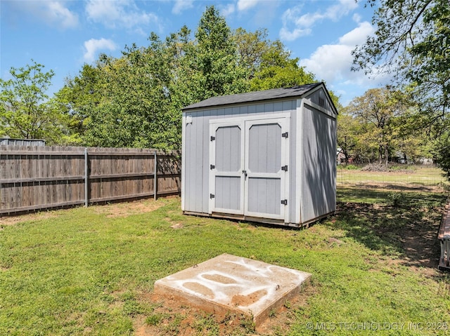view of shed featuring fence