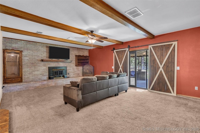 living room with visible vents, a brick fireplace, carpet floors, and beamed ceiling