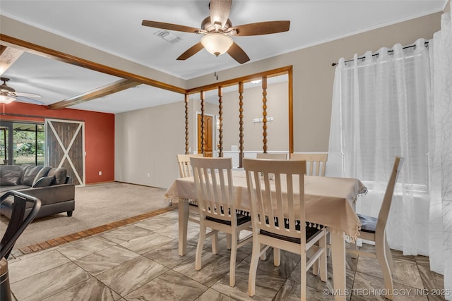 dining room featuring visible vents, baseboards, ornamental molding, ceiling fan, and light carpet