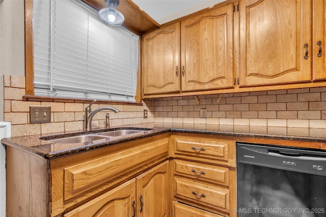 kitchen with backsplash, a sink, black dishwasher, and dark stone counters