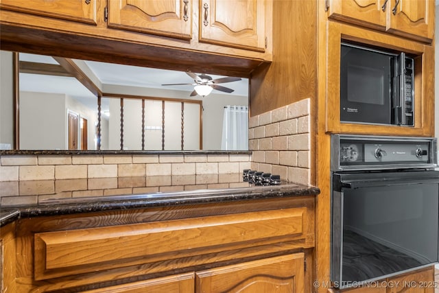 kitchen featuring ceiling fan, brown cabinets, black appliances, dark stone counters, and backsplash