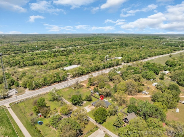 birds eye view of property with a view of trees