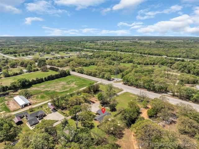 drone / aerial view featuring a view of trees