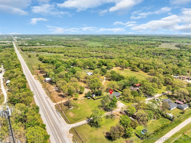 birds eye view of property featuring a forest view