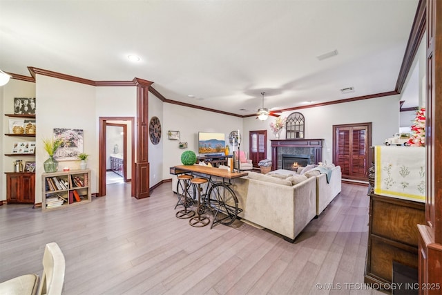 living area with baseboards, a warm lit fireplace, ceiling fan, recessed lighting, and wood finished floors