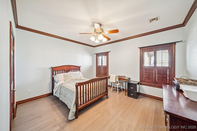 bedroom featuring light wood-type flooring, crown molding, baseboards, and visible vents