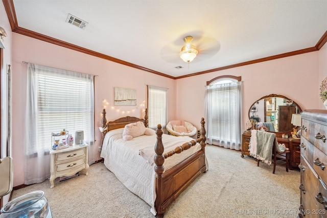 bedroom featuring crown molding, visible vents, a ceiling fan, and light colored carpet