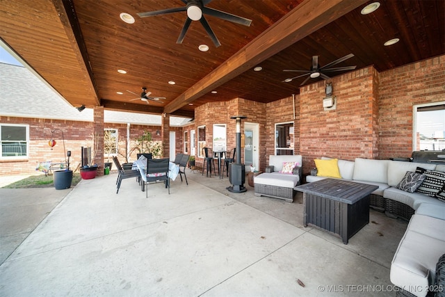 view of patio with outdoor dining space, ceiling fan, and an outdoor hangout area