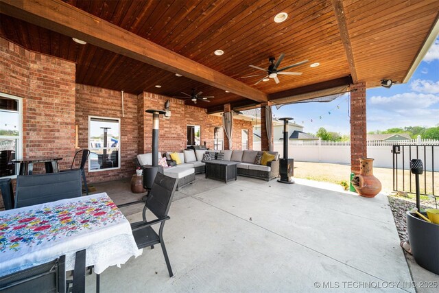 view of patio / terrace featuring fence, a ceiling fan, and an outdoor hangout area