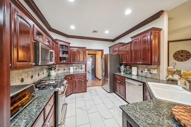 kitchen with stainless steel appliances, recessed lighting, a sink, and dark brown cabinets