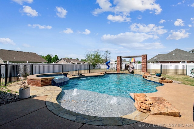 view of swimming pool featuring a patio, a fenced backyard, and a pool with connected hot tub