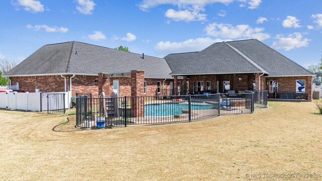 view of pool with fence, a fenced in pool, a patio, and a lawn