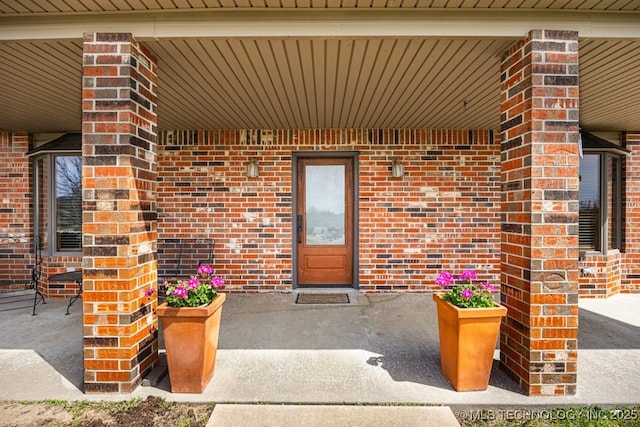 property entrance featuring brick siding