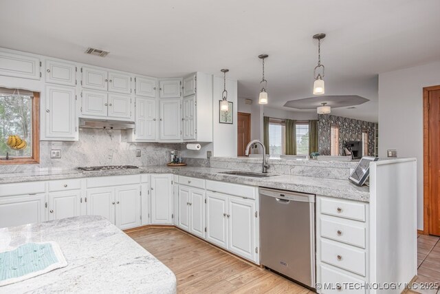 kitchen featuring a sink, visible vents, white cabinets, and stainless steel appliances