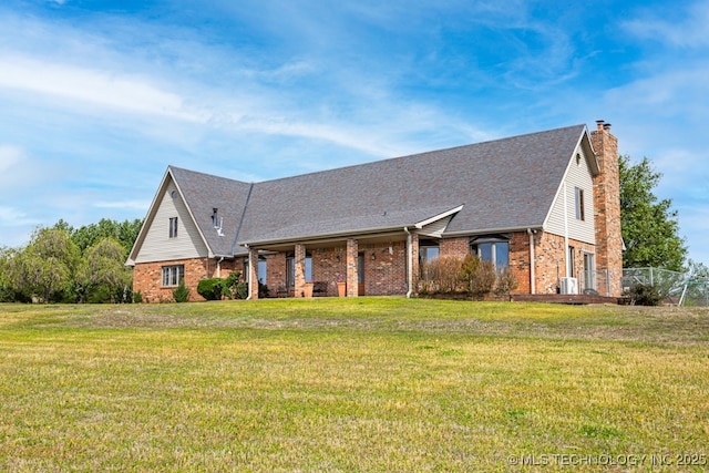 single story home featuring brick siding, a front lawn, a shingled roof, and a chimney
