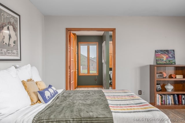 bedroom with wood finished floors