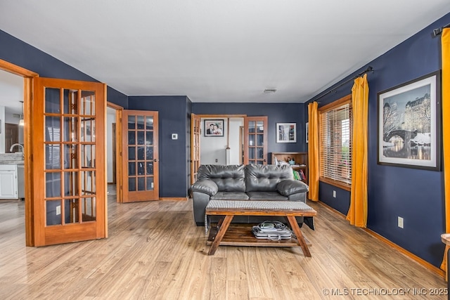 living room featuring visible vents, french doors, and wood finished floors