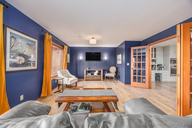 living room featuring wood finished floors and baseboards