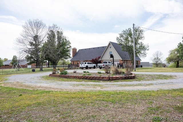 view of yard with fence and curved driveway
